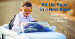 little boy steering toy car
